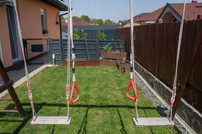 two swings in the backyard of a house at Perfect stay in Šentilj