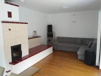 a living room with a couch and a fireplace at Počitniška hiša Nad Sočo in Bovec