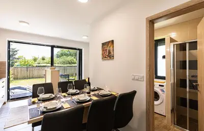 a dining room with a long table and chairs at Apartmaji BANONIA in Veržej