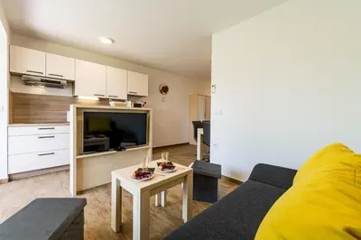 a living room with a couch and a table at Apartmaji BANONIA in Veržej