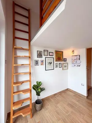 a staircase in a room with a potted plant at Lakefront Bled - Rooms & Apartments in Bled