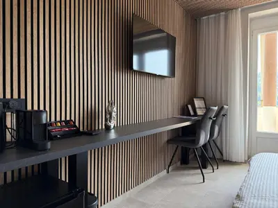 a room with a desk and a mirror on a wall at Lakefront Bled - Rooms & Apartments in Bled