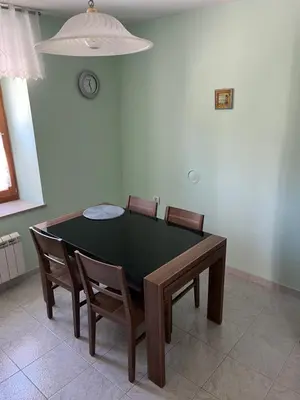 a dining room table and chairs in a room at Apartmaji Klabjan - Kaki in Osp