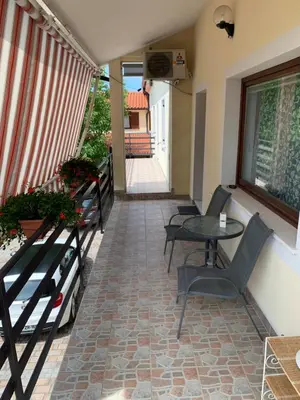 a patio with a table and chairs on a balcony at Apartmaji Klabjan - Kaki in Osp