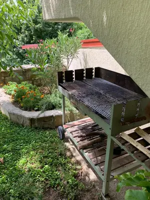 a bench sitting in the grass next to a garden at Apartmaji Klabjan - Kaki in Osp