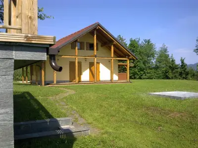 a house with a large yard with a building at Gozdarjeva koča nad Rimskimi Toplicami in Dol pri Hrastniku