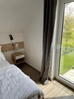a bedroom with a bed and a large window at Rooms Minka in Kamna Gorica