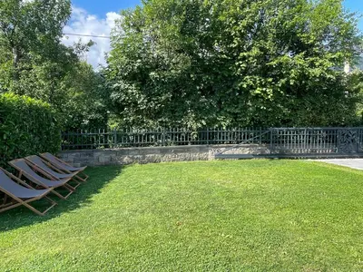 two lawn chairs sitting in a yard next to a fence at Rooms Minka in Kamna Gorica
