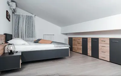 a bedroom with a large bed and a dresser at Istriana boutique apartment in Nova Gorica