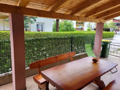 a wooden table and a bench on a patio at Apartma Patrik in Kobarid