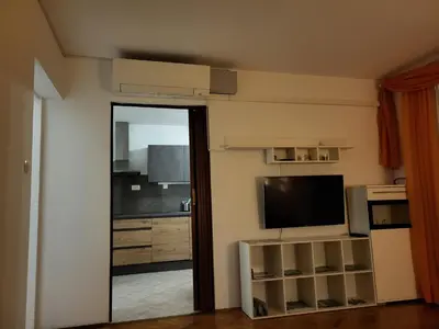a living room with a flat screen tv and a mirror at Apartma Patrik in Kobarid