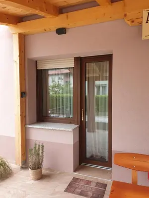 a glass door on a house with a porch at Apartma Patrik in Kobarid
