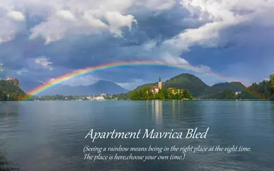 a rainbow over a body of water with a castle at Apartment Mavrica Bled in Bled
