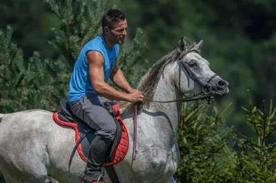 a man riding on the back of a horse at Apartment Mavrica Bled in Bled