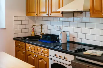 a kitchen with a sink and a stove top oven at Stol Apartments in Žirovnica