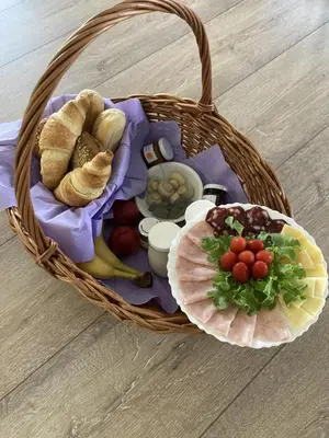 a basket filled with bread and vegetables on a table at Apartma HIŠKA in Dobravlje