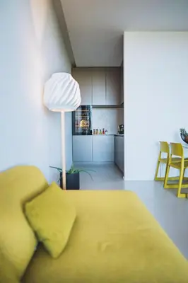 a living room with a yellow couch and a kitchen at VILLA ZEROU in Kojsko
