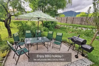 a table and chairs with an umbrella and a grill at Deerwood-Sky Attic with Bled Castle View-NO KITCHEN in Bled