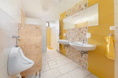 a bathroom with two sinks and a toilet at Glamping Mohorjev grunt in Preddvor