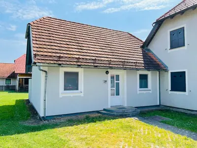 a white house with a red roof at Hiška Orel Terme Čatež in Čatež ob Savi