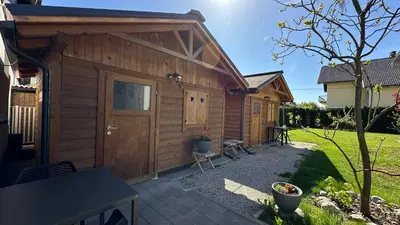 a wooden cabin with a door and a patio at Vila Eva Lesce - Bled in Lesce