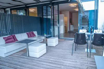 a lobby with a couch and tables and chairs at Hana - Apartments in Ljubljana