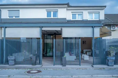 a building with a gate in front of a house at Hana - Apartments in Ljubljana