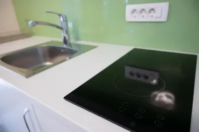 a kitchen counter with a sink with an ipod at Hana - Apartments in Ljubljana