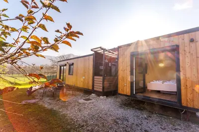 a tiny house with a large window on the side of it at Mobile House Vegov hram in Dol pri Ljubljani