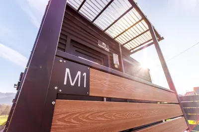 a wooden bench with the letter m on it at Mobile House Vegov hram in Dol pri Ljubljani