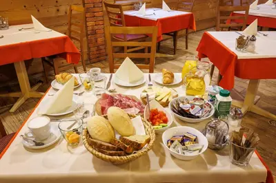 a table with breakfast food on it in a restaurant at Mobile House Vegov hram in Dol pri Ljubljani