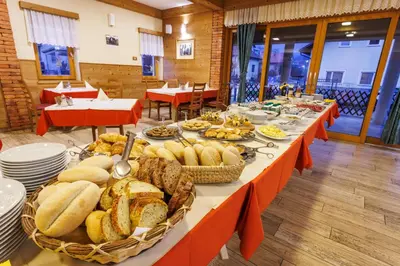 a long table filled with bread and baskets of food at Mobile House Vegov hram in Dol pri Ljubljani