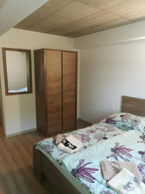 a bedroom with a bed and a cabinet with towels on it at Sobe, Rooms B&B - Vina Kauran in Zgornji Jakobski Dol