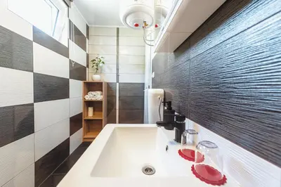 a bathroom with a tub and a sink at Holiday Homes I&G by the river next to Olimje in Kozje
