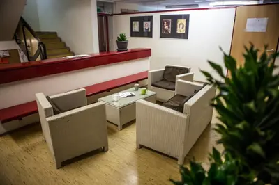 a waiting area with chairs and a table in a store at Hostel DIC in Ljubljana
