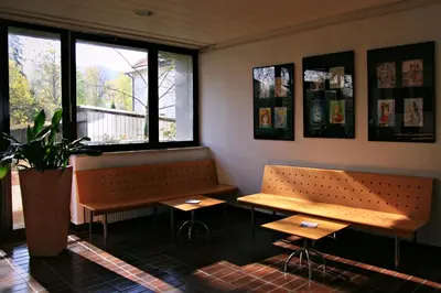 a room with two benches and a potted plant at Hostel DIC in Ljubljana