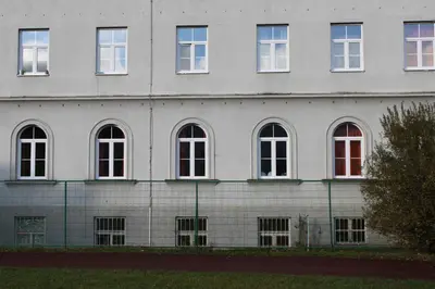 a white building with many windows on it at Hostel DIC in Ljubljana