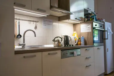 a kitchen with a sink and a refrigerator at Hostel DIC in Ljubljana