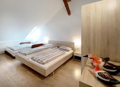 a bedroom with two beds and a bird on a table at Apartments Katrca Ljubljana in Ljubljana