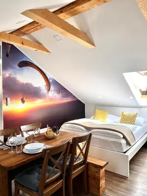 a bedroom with a bed and a table with a dining room at BeeWood apartment in Križe