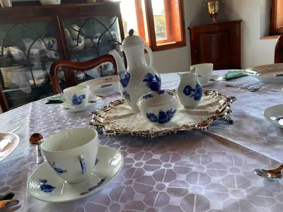 a table with a tea pot and cups on it at Villa Ruska dača in Ljubljana