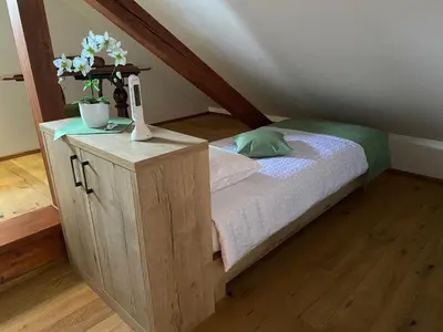 a bedroom with a bed with a cabinet with flowers on it at Villa Ruska dača in Ljubljana