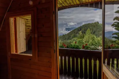 a window of a cabin with a view of the mountains at Fairytale Cottage - Peaceful Getaway Near Bled in Zgornje Gorje