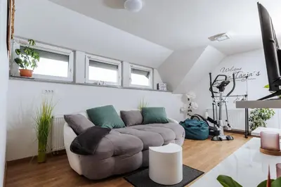 a living room with a couch and some windows at Tanja s Holiday Home in Nature with sauna and hot tub in Gorica pri Slivnici