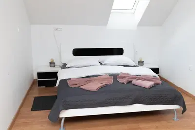 a bedroom with a bed with two pink towels on it at Tanja s Holiday Home in Nature with sauna and hot tub in Gorica pri Slivnici