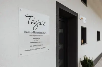 a sign on the side of a building at Tanja s Holiday Home in Nature with sauna and hot tub in Gorica pri Slivnici