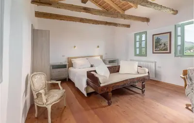a bedroom with a bed and a couch and a chair at Lovely Home In Kojsko With Sauna in Kojsko