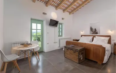 a bedroom with a bed and a table and chairs at Lovely Home In Kojsko With Sauna in Kojsko