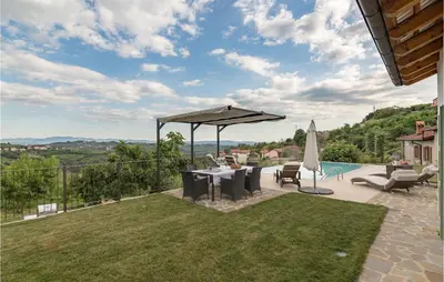 a patio with a table and an umbrella and a pool at Lovely Home In Kojsko With Sauna in Kojsko