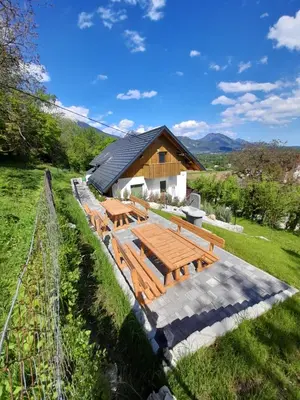 a picnic table in front of a building at APARTMAJI GORENC in Bled